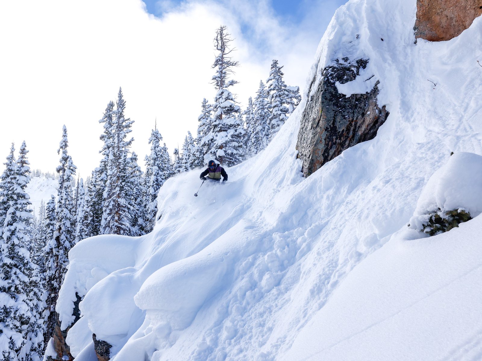Alex skiing deep backcountry powder in the mountains above Crested Butte