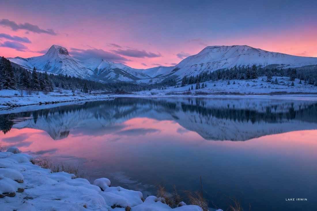 Pink winter sunset reflected in Lake Irwin