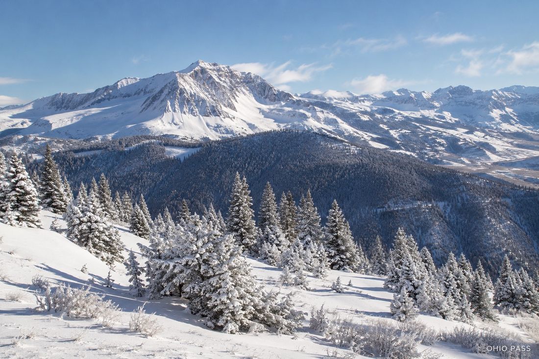 Snow-covered peaks and frosted pines at Ohio Pass in winter